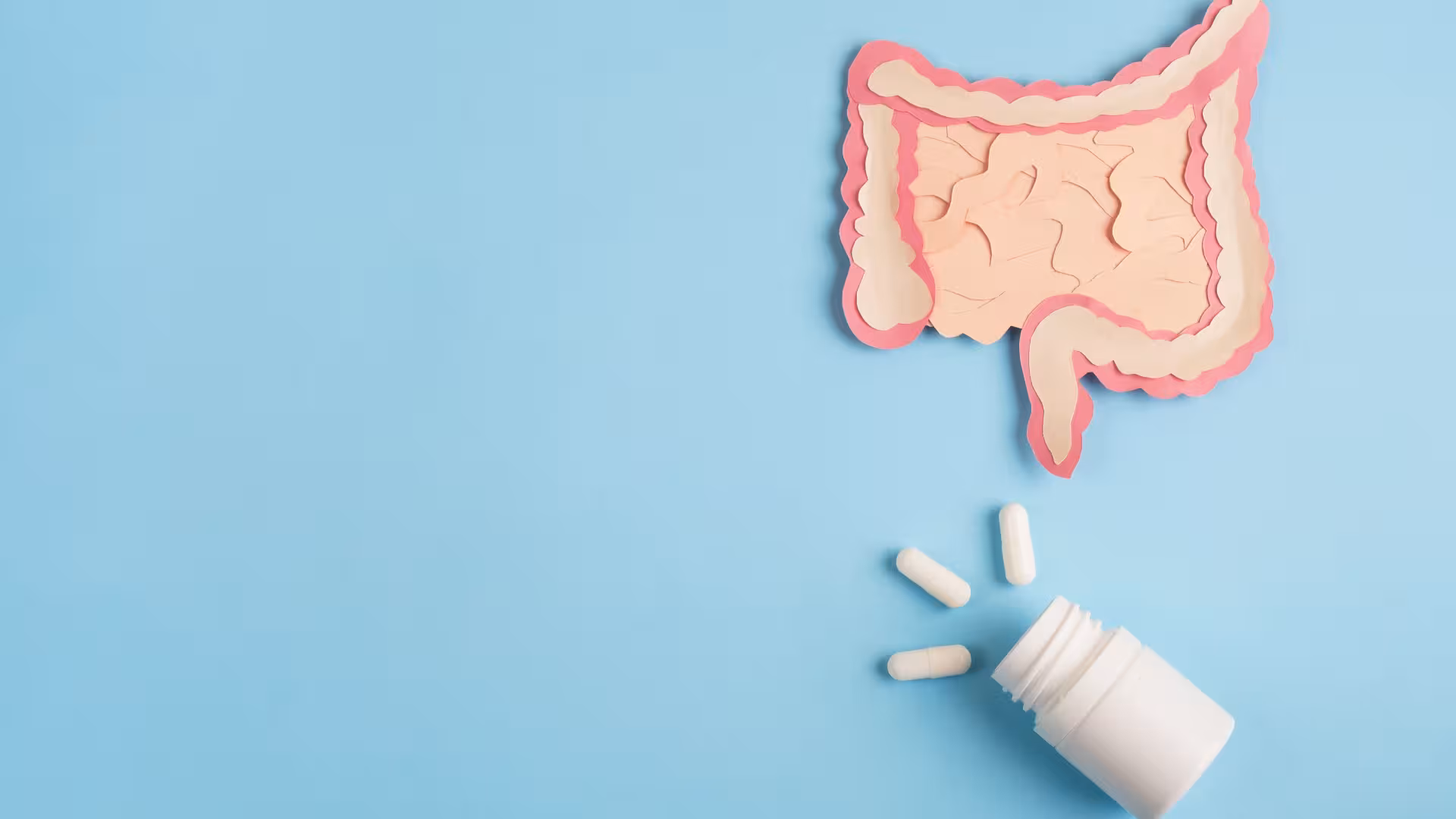 White bottle with 3 pills underneath cartoon of the digestive tract